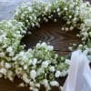 An airy halo of clustered baby&rsquo;s breath, hand-tied with a satin ribbon
