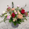 A natural style arrangement with lots of fluidity- Ranunculus and Anemones paired