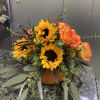 Orange and yellow flowers in a pumpkin container