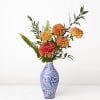 Spectacular locally-grown dahlias and greenery trumpet out of an elegant blue chinoisserie