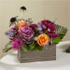 Spiderly purple scabiosas hang over this nestled tuft of blooms, adding a