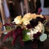 This stunning holiday arrangement is made up of holiday black roses, whites