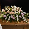 A beautiful casket arrangement of soft pastel blooms