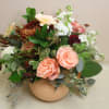 peaches and sage, rust and cranberries all fill a peach vase. 