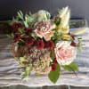 A soft and elegant arrangement that blends soft colors and rich rust