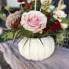 A soft and elegant arrangement that blends soft colors and rich rust