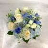 A soft palette of light blue hydrangea, blue delphinium, white roses, and