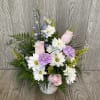 Beautiful fresh cut flowers arranged in a floral ceramic mug. Flowers and