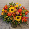 Bring the warmth of autumn indoors with our Harvest Glow Bouquet. Bursting