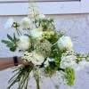 A beautifully wrapped bouquet with a selection of simple &amp; soft blooms