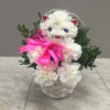 White carnations kitty cat in a white basket with a pink satin