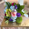 This beautiful spring handheld includes blue hydrangea, dark and light pink roses