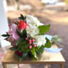 Hot pink and orange roses, green and white hydrangea, pink hypericum, green