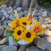 Fresh sunflowers artfully arranged in a white pumpkin vase will bring you
