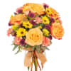 A lush domed floral arrangement featuring peach and orange roses with fall