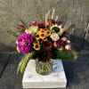 Chocolate sunflowers,  *Gerber daisy, Roses, spray roses, carnations, chrysanthemums, millet, a