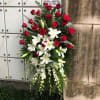 Pure white lilies and dendrobium orchids mingle with red roses, white asiatic