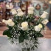 One dozen long stem White roses with assorted greens and accent flower
