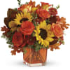 Sunny sunflowers and radiant roses in a happy orange cube vase bring