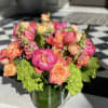Large and lush statement arrangement of green, coral, orange, peach , and