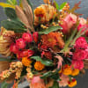 This is a bright, textured arrangement of fall blooms. Designers choice with