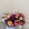 Lush Roses in Berry colors in a garden-like setting. Flowers may vary