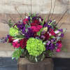 A beautiful arrangement in vibrant colors and a variety of flowers including