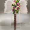 Featherd Angel Wings on a stand with groupings of floral in the