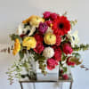 A lovely flower arrangement in a 5 inch white cube with premium