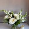 A sweet and elegant asymmetric arrangement of all whites and neutral flowers