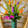 This arrangement includes birds of paradise, liatris, solidago, blue thistle, and tropical