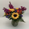 A bouquet that reflects a vibrant Charleston landmark. With yellow sunflowers, orange
