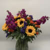 A bouquet that reflects a vibrant Charleston landmark. With yellow sunflowers, orange