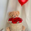 A gift set featuring a basket with roses and baby&#039;s breath, plus
