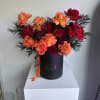 Ignite any occasion with this bold and luxurious arrangement featuring vibrant orange