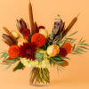 Rich autumn tones meet romantic elegance in this striking arrangement. Featuring golden