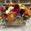 long and narrow floral arrangement of hearty long lasting mums and accent