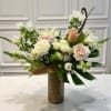 An elegant tall arrangement that blends soft blush and dusty tones with