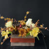 A charming blend of rustic and refined, this arrangement features a gleaming