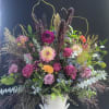 An enchanting blend of moody elegance and wild beauty, this grand arrangement