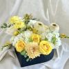 A heart-shaped box filled with a mix of fresh flowers. 

Flower types