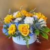 The Bright Blue Skies Bouquet is arranged by a local florist close