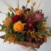 Seasonal rustic flowers arranged in a cornucopia. 