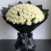 This opulent arrangement features a breathtaking 100 premium, long-stemmed white roses, meticulously