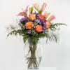 This vibrant arrangement features a cheerful mix of peachy-orange roses, soft pink