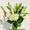 Classy white casa blanca lily and hydrangea blooms are mixed together in