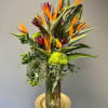 Tropical Paradise is designed in a tall cylinder style clear glass vase.