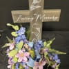 Wooden cross in a bed of silks- Deluxe is pictured