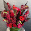 A bold bouquet of tropical red flowers &mdash; vibrant, exotic, and full