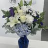 This peaceful arrangement includes roses, asiatic lilies, chrysanthemums, hydrangea, carnations, and other